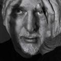 Peter Gabriel close-up with hand on face
